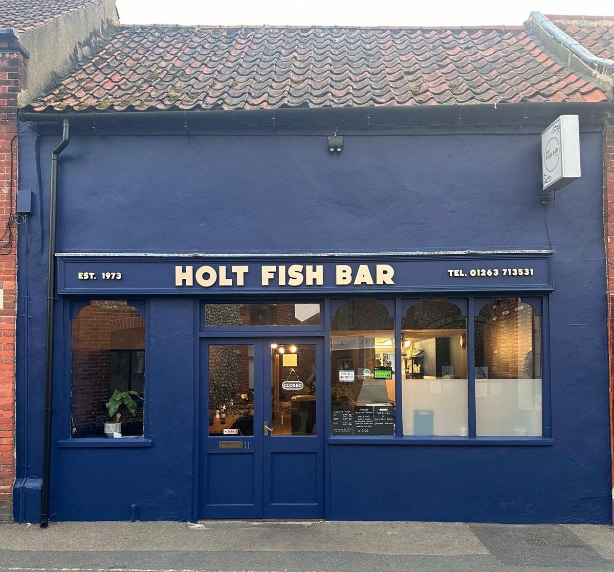 The navy-blue shopfront with HOLT FISH BAR across the fascia