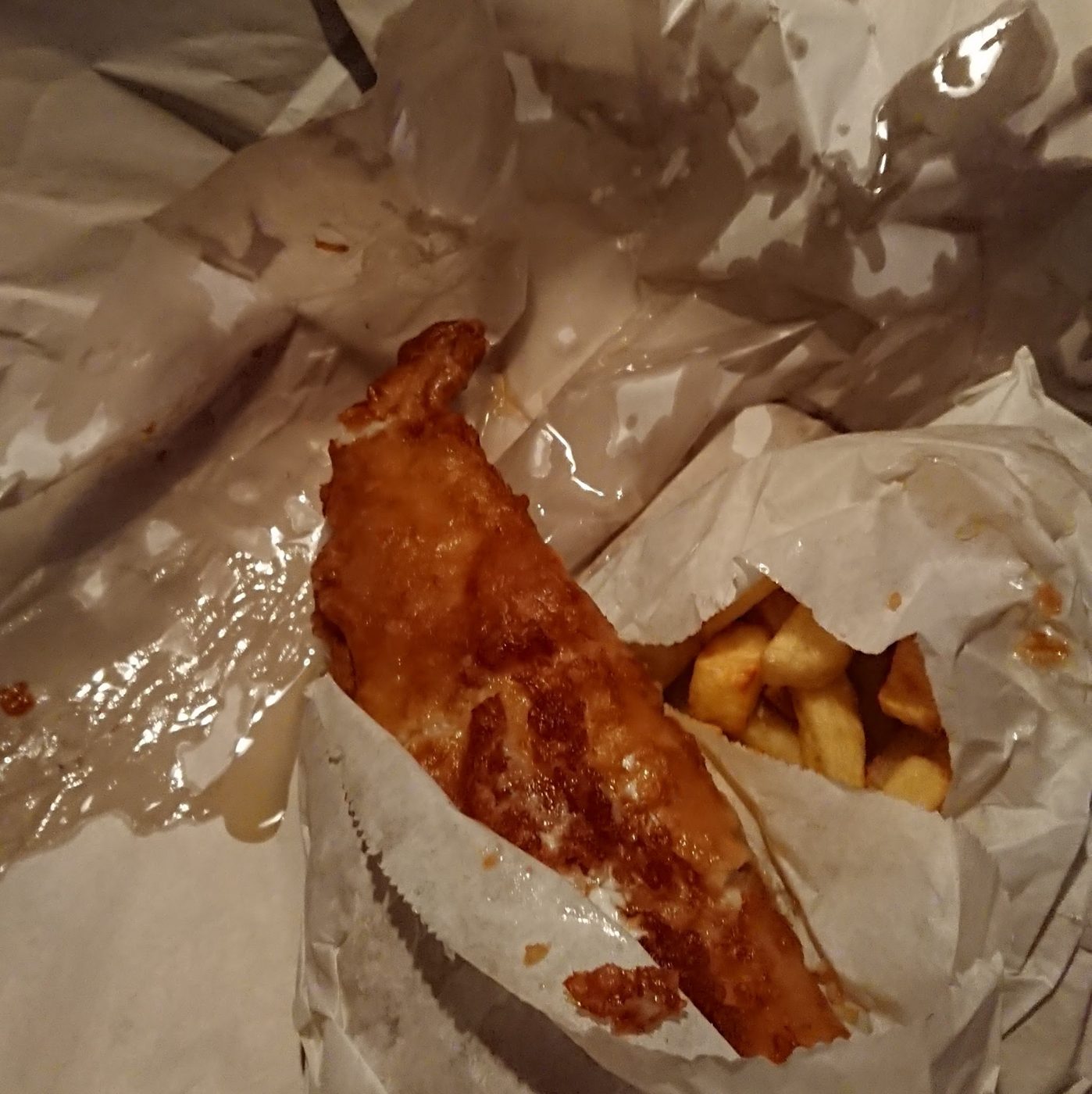 Battered fish and chips in paper